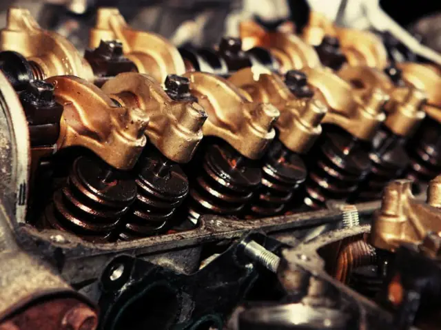 Close-up of an engine valve train being inspected