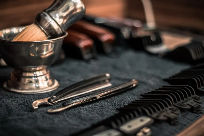 Straight razors, shaving brush and bowl on a barber's tray