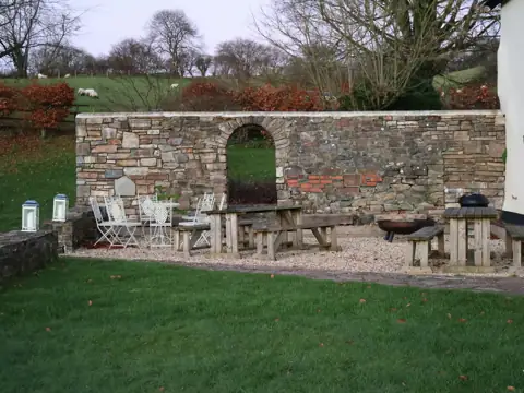 Natural stone wall and patio with outdoor furniture